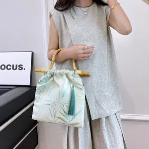 Elegant New Chinese style handbag with bamboo handles and pleated bamboo leaf print fabric