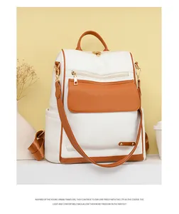 Vista frontal de una elegante mochila de cuero blanco y marrón con cremalleras