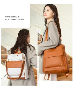Mochila versátil para mujer de gran capacidad en marrón y blanco sobre una modelo.