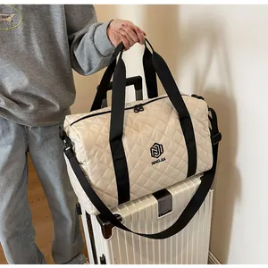 Stylish quilted travel bag displayed on a suitcase for fitness or weekend trips