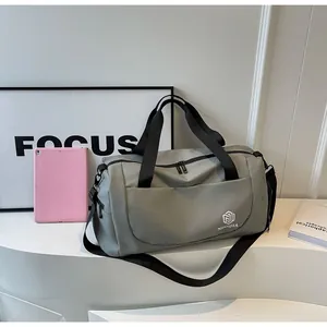 Side view of a gray large-capacity travel bag with black handles and shoulder strap
