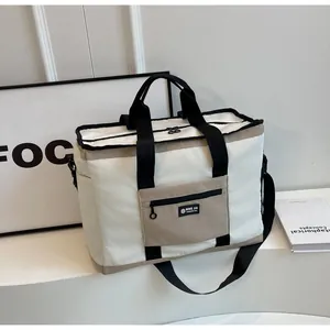 Vista frontale di un'elegante borsa da viaggio bianca con manici neri e tasca marrone