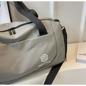 Detail shot of a grey large capacity travel bag with black straps and NINGJIA logo