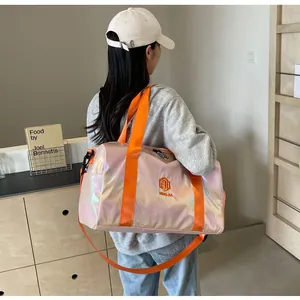 Detailansicht der großen holografischen Reisetasche mit leuchtend orangefarbenen Riemen.