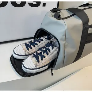 Functional grey duffel bag detail showing a dedicated side zipper compartment for shoes