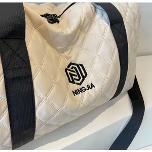 Detailed close-up showing the premium white quilted texture and NINGJIA logo of this travel bag