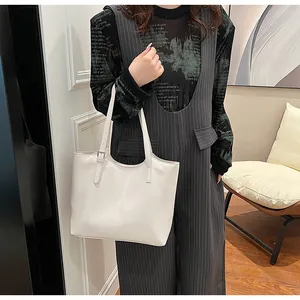 High-quality minimalist white leather tote bag shown on model for outfit inspiration