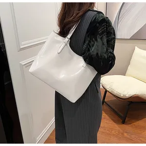Elegant white glossy large capacity tote bag for women showing shoulder strap detail