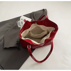 Detailed view of the red large capacity tote bag interior with beige lining and zip pocket
