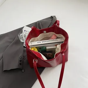 Chic minimalist red large capacity tote bag shown filled with daily essentials