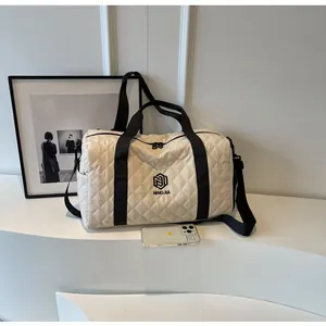 Detail view of the quilted diamond lattice travel bag with NINGJIA logo branding