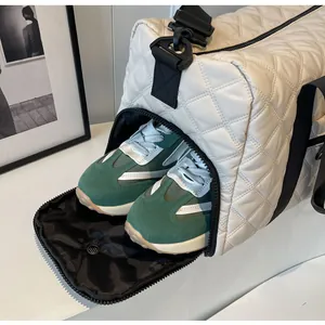 Detail view of quilted travel bag featuring independent side shoe compartment and storage