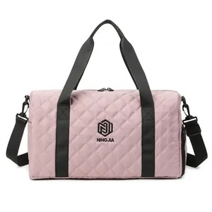 Stylish pink quilted travel duffel bag with black straps and NINGJIA logo for gym use