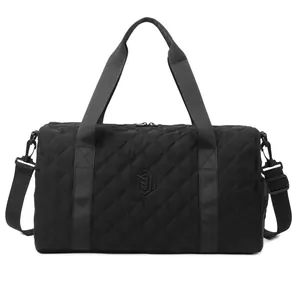 Detailed view of the quilted black travel duffel bag with shoulder strap