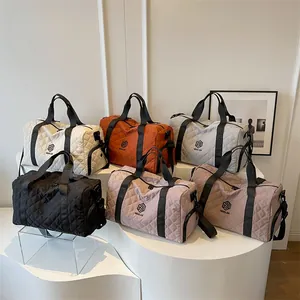 Set of quilted duffel bags in various colors for travel and sports fitness training.