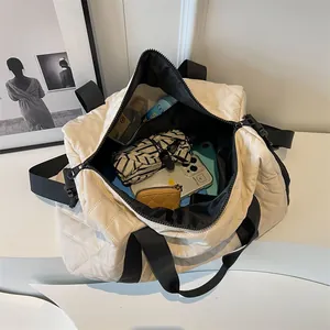 Fashionable cream quilted duffle bag for travel and fitness with large capacity