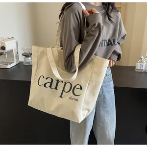 Large capacity cream canvas tote bag with minimalist carpe text for student use