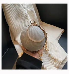 Detailed macro view of a silver spherical evening clutch with elegant gold ring handle