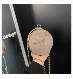 Macro view of a spherical evening clutch bag with shimmering champagne gold rhinestones