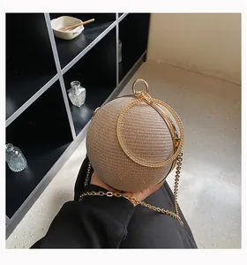 Close-up of a luxury champagne rhinestone spherical clutch bag with gold-tone handles