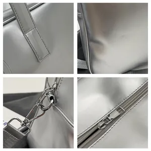 Detailweergaven van een zilveren reistas met duurzame metalen hardware en fijne stiksels.