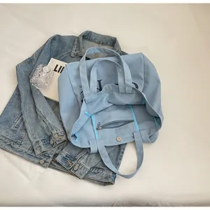 Detailed view of large capacity light blue canvas tote bag interior with zipper pocket