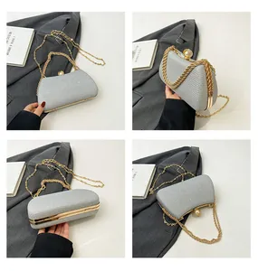 Detailed four-way views of elegant silver glitter evening clutch with gold chain and pearl clasp.