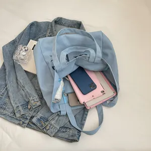 Large capacity light blue canvas tote bag showing its spacious interior storage