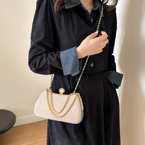 Elegant champagne glitter clutch bag with pearl clasp and gold chain strap