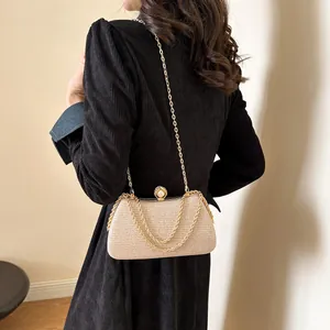 Elegant champagne gold glitter evening clutch bag with gold chain and pearl clasp
