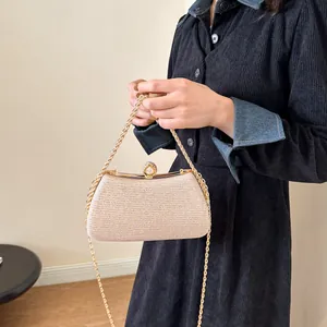 Champagne sparkly hard shell evening clutch bag with gold chain strap and pearl clasp