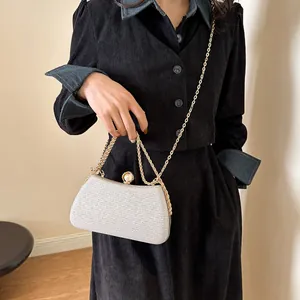 Elegant silver glitter hard shell evening clutch bag with gold chain strap detail