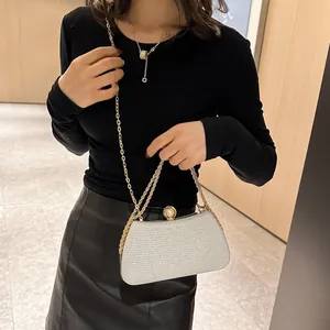 Detailed macro view of a silver glitter evening clutch bag with elegant gold chain strap