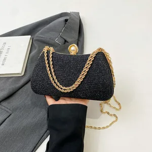 Elegant black glitter evening clutch with gold chain strap and pearl clasp