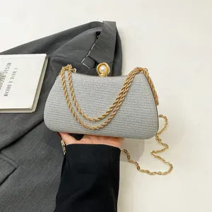 Silver glitter evening clutch bag with gold chain strap and elegant pearl clasp detail
