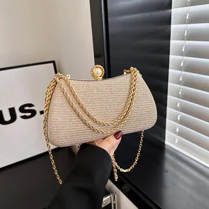 Elegant champagne gold glitter evening clutch bag with pearl clasp and gold chain straps