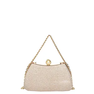 Elegant champagne gold evening clutch bag with pearl clasp and luxury chain handle
