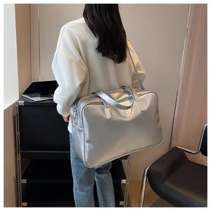 Grote zilveren metallic reistas voor dames getoond in een echte lifestyle omgeving