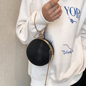 Elegant black round glitter evening clutch bag featuring a gold-tone ring handle