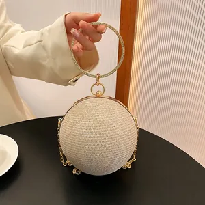 Elegant spherical evening clutch bag with sparkling crystals and a gold ring handle