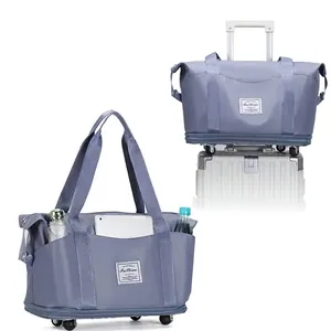 Large capacity foldable wheeled travel bag with suitcase sleeve feature