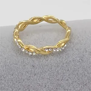 Detailed view of elegant gold twisted ring with sparkling rhinestone accents