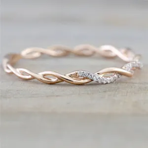 Detailed macro view of a rose gold twisted ring featuring elegant inlaid crystals
