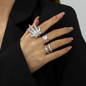 Detailansicht von silbernen Flüssigmetallringen und Blattring an der Hand eines Models