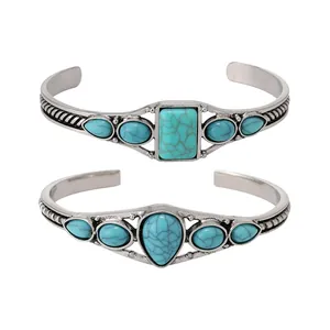 Detail view showing two Bohemian vintage silver cuff bangles with turquoise stones