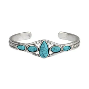 Front view of a bohemian vintage turquoise open cuff bracelet with silver engravings.