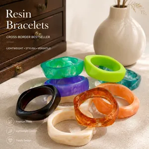 Close-up detail of irregular marbled resin bangles with stylish polished finish
