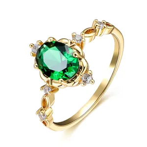 Élégante bague en or ornée d'un grand zircon vert ovale et de pierres latérales