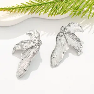 Close-up of vintage silver leaf textured earrings with intricate metal finish