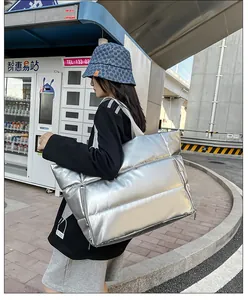 Vista detallada del bolso de viaje acolchado plateado metalizado de gran capacidad para mujer